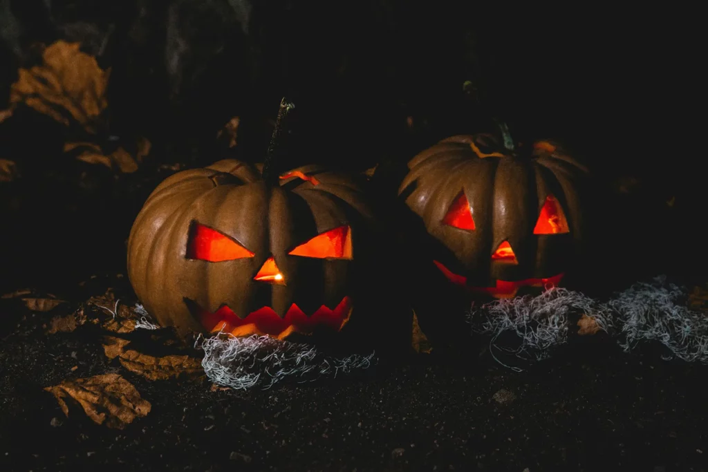 halloween, evil pumpkin jack-o-lanterns, lit up pumpkins in a dark scene